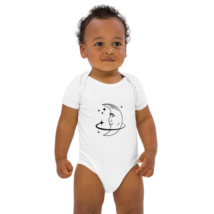 Image of baby wearing white bodysuit with image of the moon and stars in black
