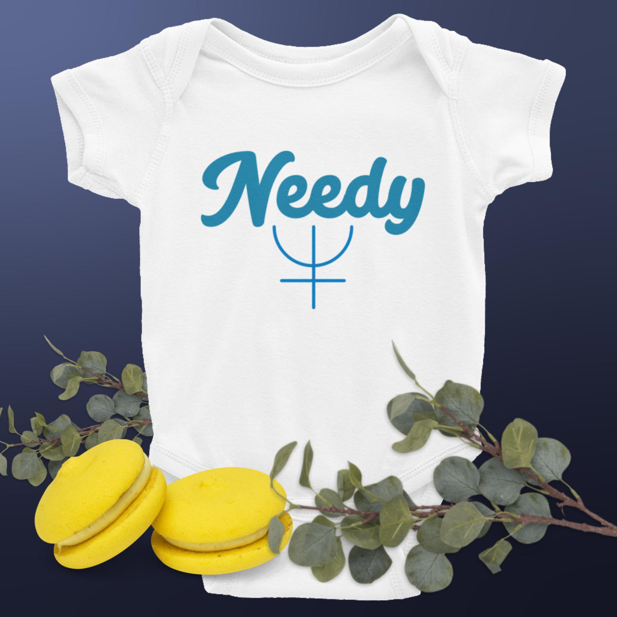 White baby short sleeve bodysuit with a Neptune symbol and the word "Needy" in blue text